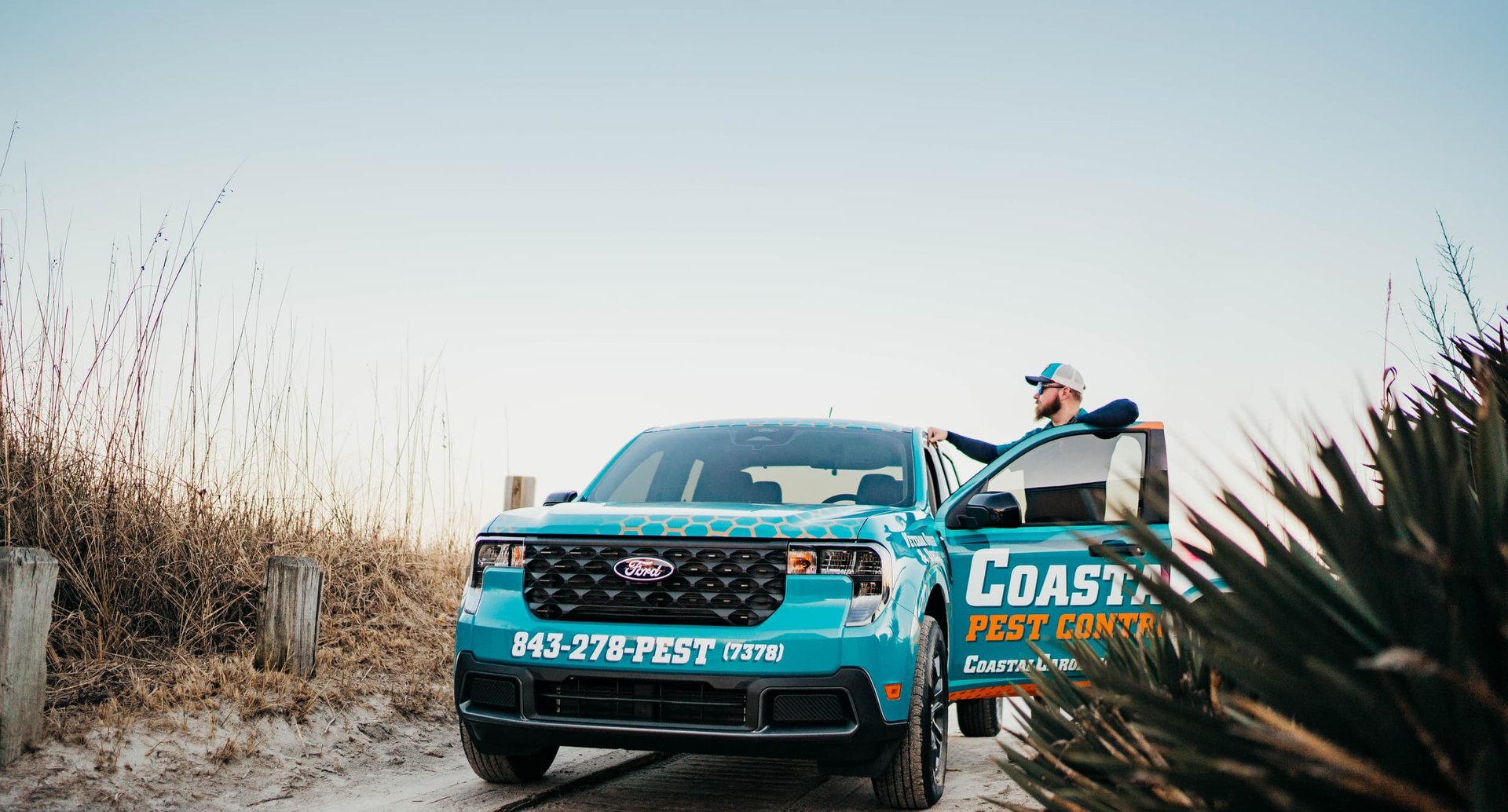 Technician performing exterior pest spray